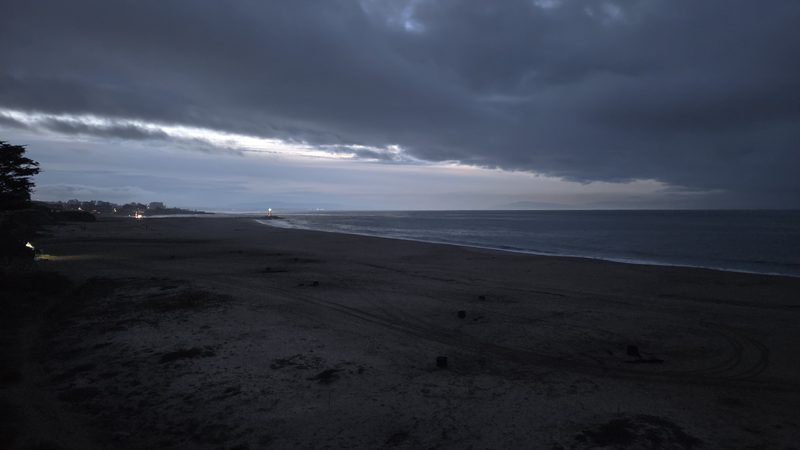 Storm clouds over the dawn beach