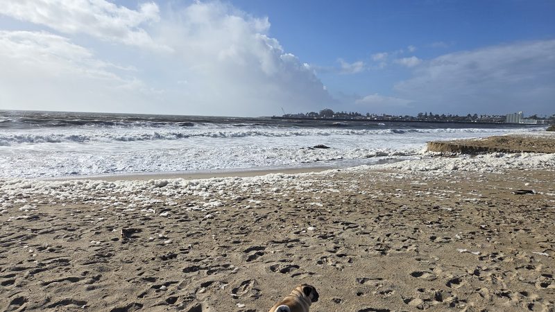 White surf under drifting clouds