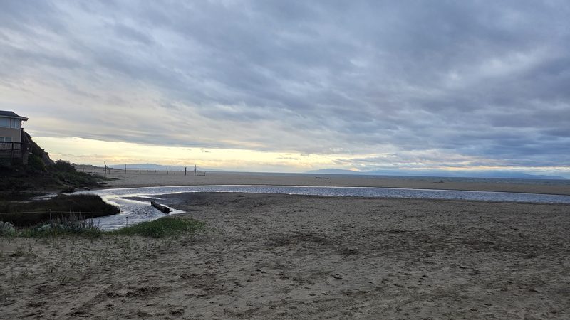Tidal creek under a grey sky