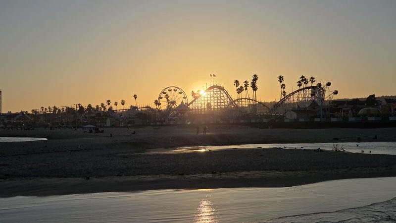 Sun setting behind the roller coaster